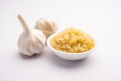 Garlic Paste or Lahsun Puree with raw whole, isolated over white background. Selective focus