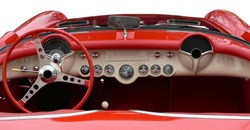 The convertible top is down in the horizontal view of the white dashboard of vintage red sportscar.  All the gauges and the steering wheel are in beautifully maintained or restored condition.