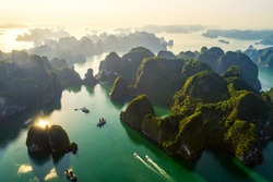 Aerial view floating fishing village and rock island, Halong Bay, Vietnam, Southeast Asia. UNESCO World Heritage Site. Junk boat cruise to Ha Long Bay. Popular landmark, famous destination of Vietnam