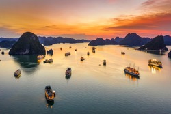 Aerial view of sunset and dawn near rock island, Halong Bay, Vietnam, Southeast Asia. UNESCO World Heritage Site. Junk boat cruise to Ha Long Bay. Popular landmark, famous destination of Vietnam