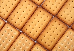 rectangle cookies stacked in rows. Close-up biscuit.  abstract golden texture background