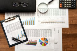 Financial printed paper charts, graphs,calculations, calculator
 and diagrams