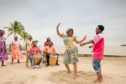 Couple of friends dancing to the rhythm of Punta music, on a Guatemalan Caribbean beach.