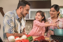 Latino family happily cooking on a day of celebration.