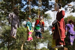 colourful handmade hanging marionette puppets on strings in Myanmar