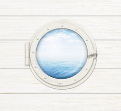 ship window or porthole on wooden wall with sea or ocean visible through it