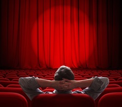 man sitting alone in  empty theater or cinema hall