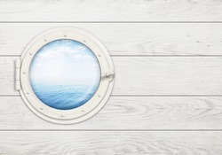 ship window or porthole on white wooden wall with sea or ocean horizon