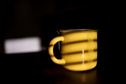 Yellow Coffee Cup With Shadow From Window.