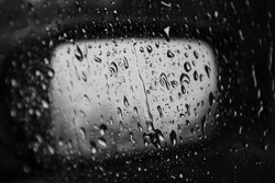 Monochrome Rain drops on window with reflection