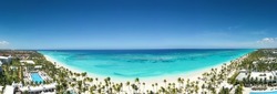 Bounty and pristine sandy shore with coconut palm trees, caribbean sea washes tropical coastline. Arenda Gorda beach. Dominican Republic. Aerial panorama view