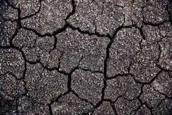 Dry cracked ground during drought. Gray dried and cracked ground earth background, Close up of dry fissure ground, fracture surface, white cracked texture, for designers.