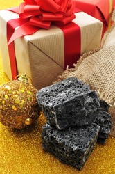 some lumps of candy coal and some christmas ornaments and gifts