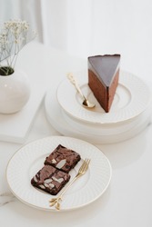 Double Rich brownies cake and Rich premium sliced Chocolate mousse cake on the white plate in the white background