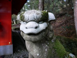It is the scenery of the Japanese shrine. Called Koma-inu.A pair of lion-like guardian figures placed at each side of a shrine or temple entrance; believed to ward off evil spirits.