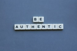 ' Be Authentic ' word made of square letter word on grey background.