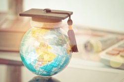 Graduated study abroad international Conceptual, Graduation hat on top Earth globe model map with Radar background. Congratulations to graduates, Studies lead to success in world wide. Back to School