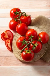 Delicious red ripe tomatoes whith a jar of their traditional sauce.