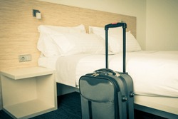 Prepared fresh bed, scene in hotel room. Horizontal retro toned shot