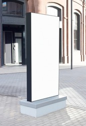 Blank white vertical pylon stand mockup brick building, side view. Empty advertising tower for commercial information mock up. Clear rectangular monitor or light box for advertise mokcup template.