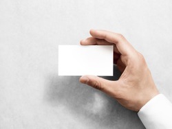 Hand holding blank plain white business card design mockup. Clear call id card mock up template hold arm. Visit pasteboard paper surface display front. Small pure offset namecard print. Logo branding