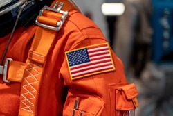 Close up of a USA flag on a space suit.