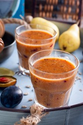 Smoothies with plum, pear, sunflower seeds and honey, selective focus