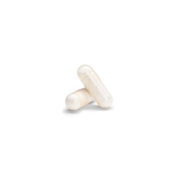 Close-up of a couple pills or capsules color yellow on isolated white background.