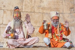 Hindu sadhu holy man, sits on the ghat