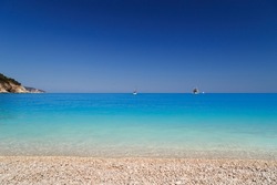 Fantastic view at Myrtos Beach with turquoise and blue Ionian Sea water. Summer scenery of famous and extremely popular travel destination in Cephalonia, Greece, Europe