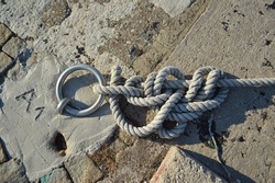 Tangled nautical rope tied to a dock link