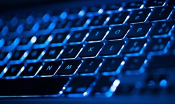Closeup of laptop keyboard illumination, backlit keyboard