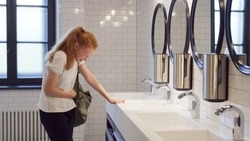 Teenage girl crying in school bathroom. Upset teen student cry in campus toilet having problems at school