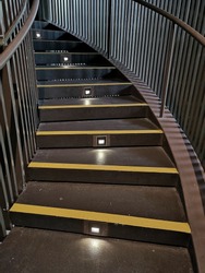 Stairs with lighting and yellow anti-slip treads and nosings. 