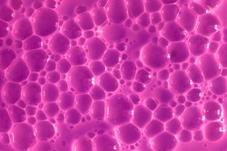 Bubble purple background texture. Berry gel to cleanse the skin of the face and body. Spa treatments, skin care. Bath foam, detergent. Slime pink.