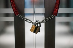 Close up The office door locked with Metal chain and padlock 
