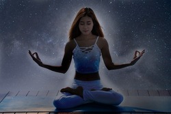 Young spiritual meditation woman with star background.
