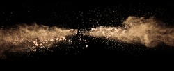 Abstract colored brown powder explosion isolated on black background. High resolution texture