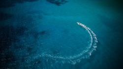 Aerial view of speed boat in motion. Water transportation and summer leisure time activity.