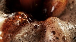 Detail of coffee drink being pour into foamy coffee drink. Abstract coffee background.