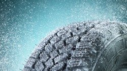 Winter Car tire with snow in detail, macro photo, winter weather concept. Free space for text.