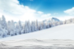 Winter background with pile of snow and blur landscape. Copyspace for text