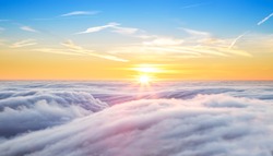 Beautiful sunset above clouds from airplane perspective. High resolution image