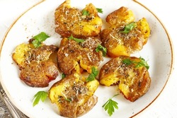 crushed potatoes. smashed potatoes. recipes for Australian cuisine. the potatoes are boiled in a shell, broken and baked in an oven with spices. 
