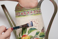 technique decoupage. decorating objects with paper napkins with a pattern. A ready-made drawing is used and an appliqué is made.
