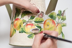 technique decoupage. decorating objects with paper napkins with a pattern. A ready-made drawing is used and an appliqué is made.
