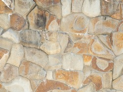 Textured sandstone wall masonry cladding. Flat stone masonry texture. Wall cladding with coarse decorative stone. Not a seamless texture.