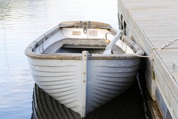 White wooden boat moored at the wharf