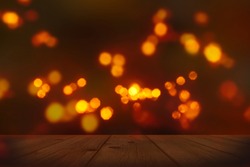 festive background with blurry lights, empty wooden table in foreground with bright candlelight bokeh on dark blurred backdrop, celebration at night concept