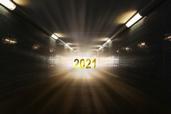 light and 2021 date at the end of the tunnel, symbol for hope for 2021, happy new year 2021 concept